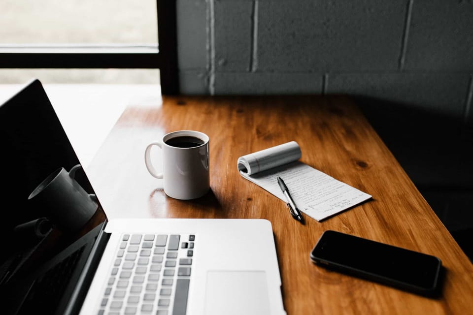 Laptop, coffee mug on a desk - Photo by Andrew Neel on Unsplash